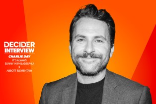 Charlie Day in black and white on an orange background