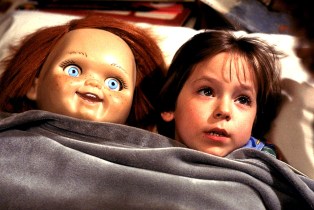 Chucky the doll and boy in bed together